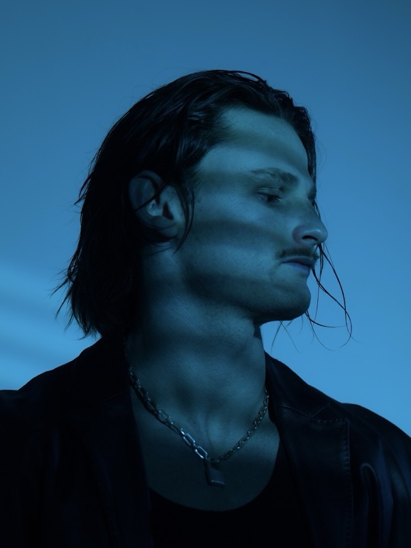 Audent side profile portrait in blue light, press photo